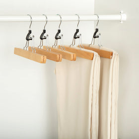 Amazon Basics wooden pants hanger keeps jeans and slacks wrinkle-free.