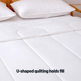 Amazon Basics Cooling Comforter in bed demonstrates cooling blanket for better sleep comfort.