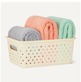 Amazon Basics BPA-free plastic basket close-up highlights durable, decorative design.