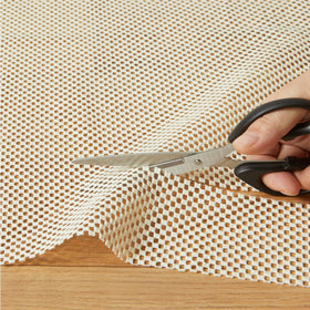 Under a rug on floor demonstrating slip resistance