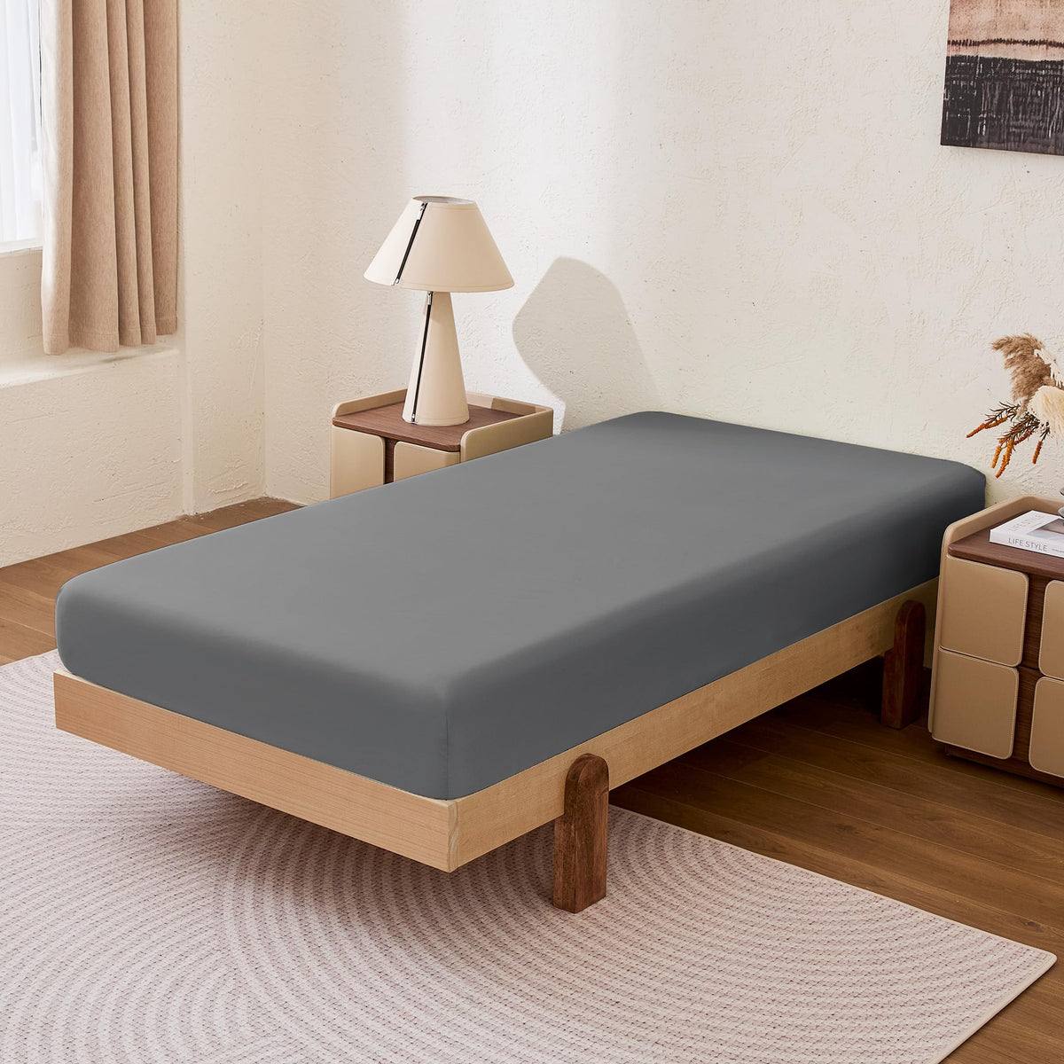 Amazon Basics queen fitted sheet two-pack in dark gray ready for quick bed changes.