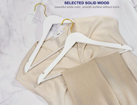Amber Home white wood hanger with gold hook, grooved notches for delicate straps.