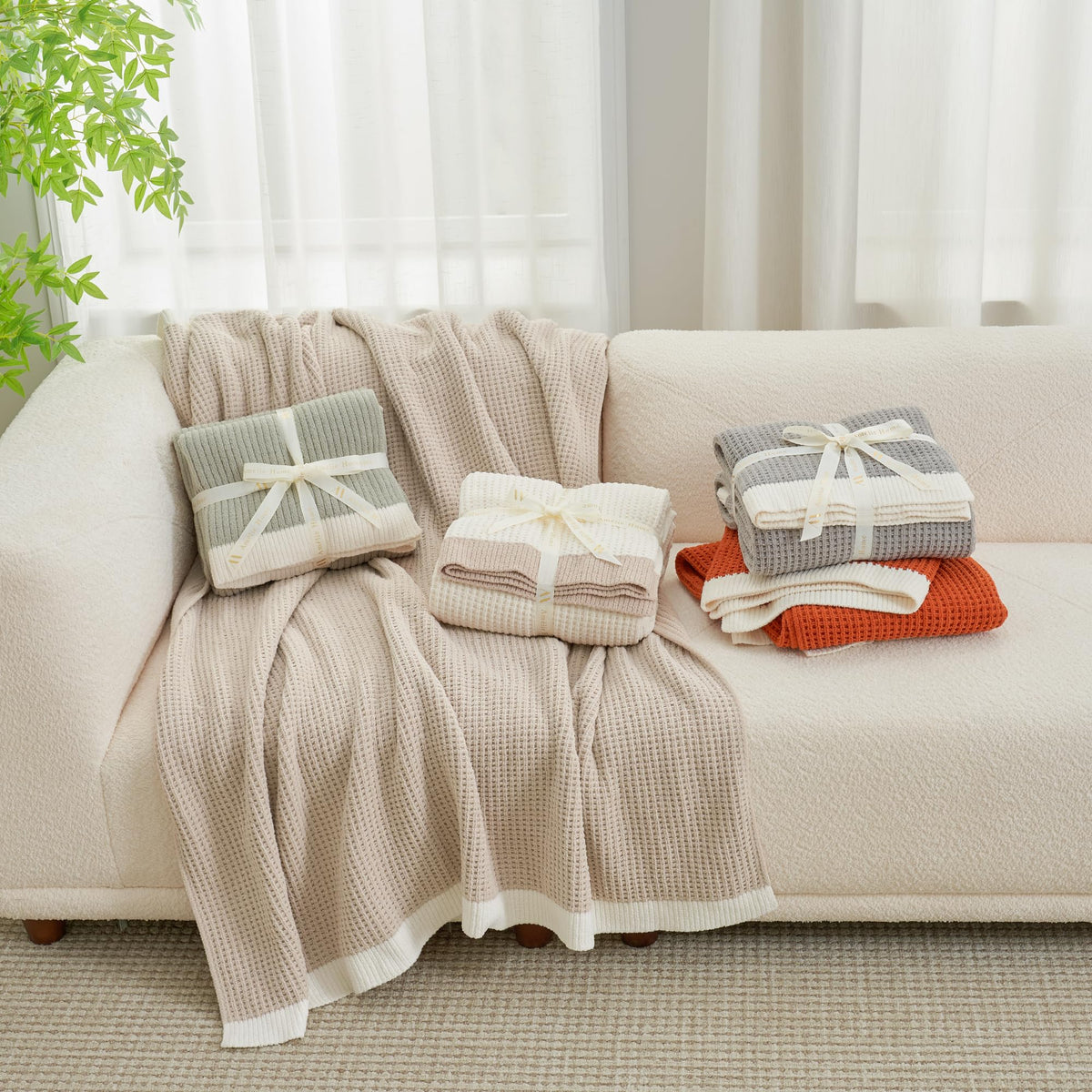 Amélie Home chenille throw layered on a bed for cozy relaxation.