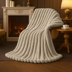 Amélie Home faux fur throw on sofa in beige for cozy evenings