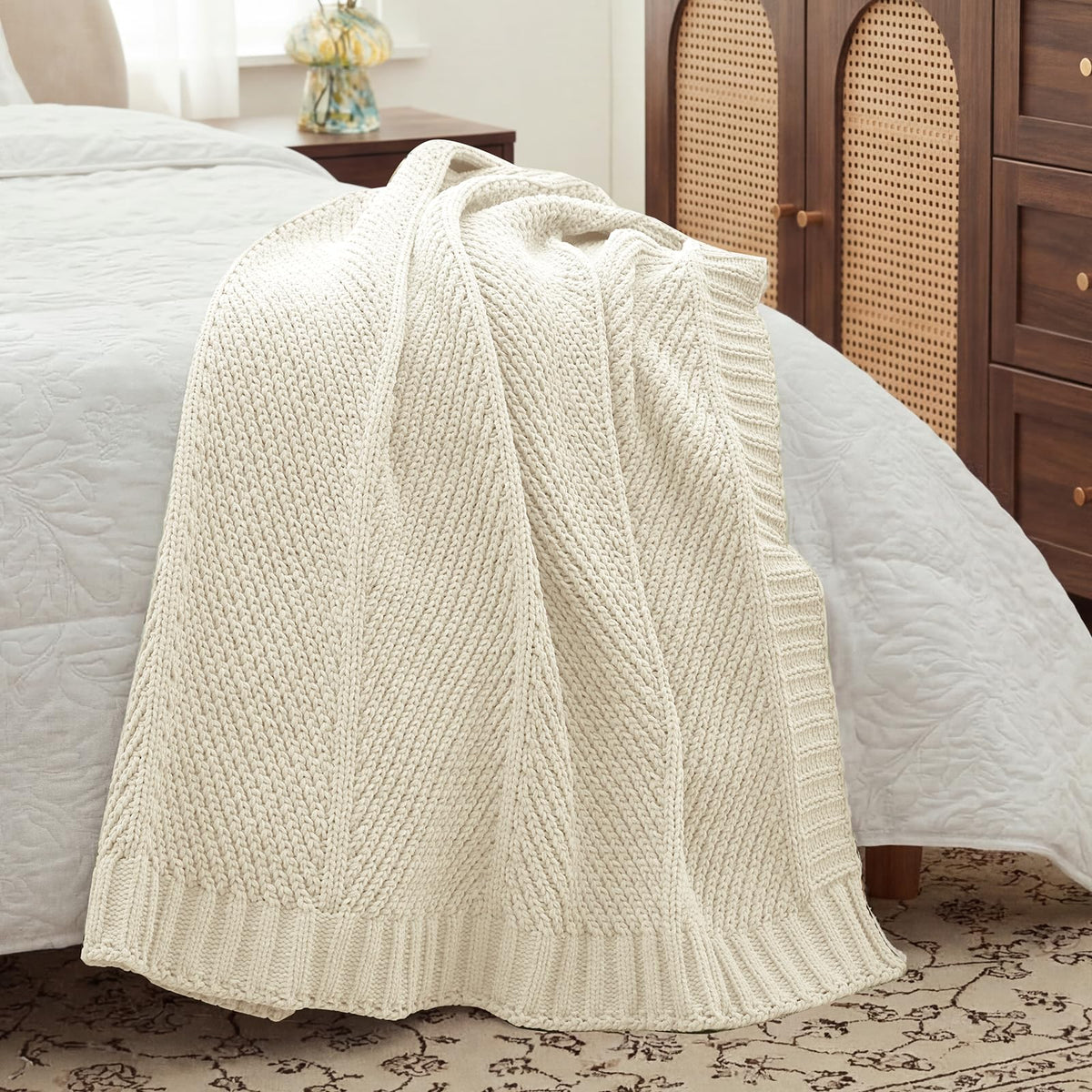 Amélie Home cozy throw at bedside invites quick warmth.
