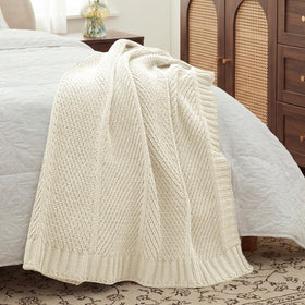 Amélie Home cozy throw at bedside invites quick warmth.