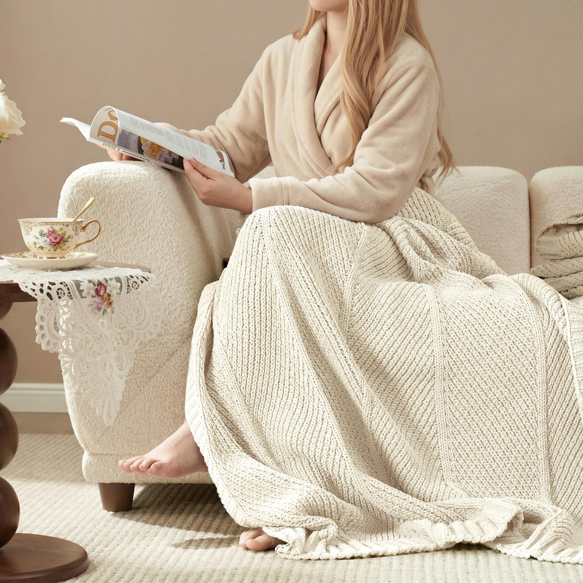 Amélie Home ivory knit throw draped on sofa for cozy lounging.