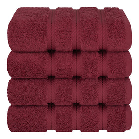 American Soft Linen Bordeaux red towels folded in a basket for guest use.