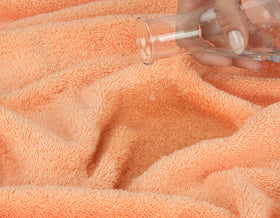 American Soft Linen peach towel packaging shot highlighting premium OEKO-TEX certified fabric.