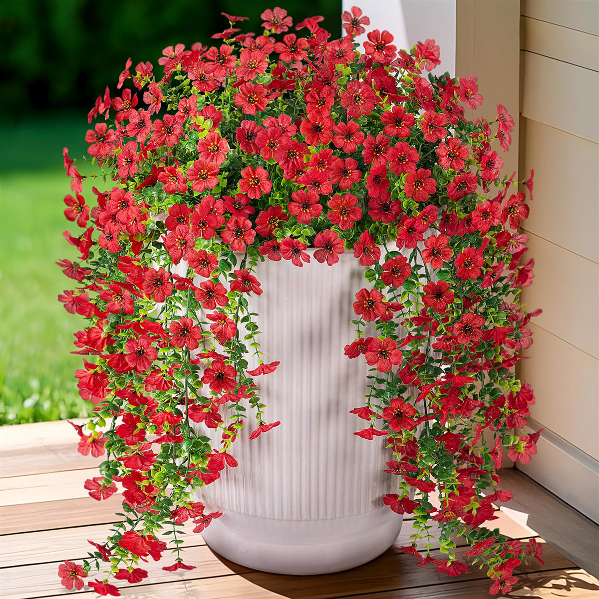 Ammyoo eucalyptus leaves with red daisies add lush greenery.