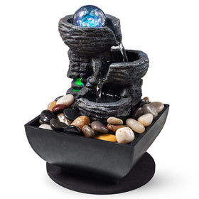 AMOOTEK tabletop fountain on a desk with rock layers and soft water flow.