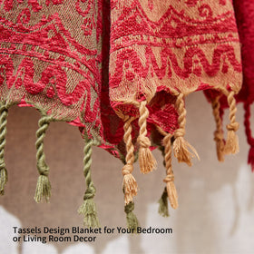 Amorus chenille throw blanket with tassels drapes over a chair