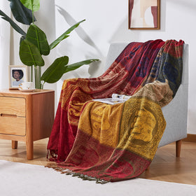 Amorus jacquard bohemian blanket shows red tribal pattern on bed