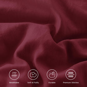Andency bedroom scene with burgundy comforter on bed