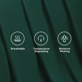 Pillowcases with matching emerald tone complete a cohesive bed setup.