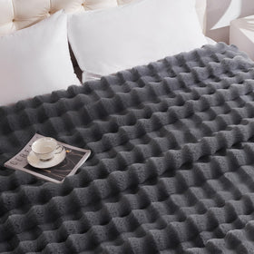 Anysay cozy blanket on a couch delivering soft warmth and comfort.
