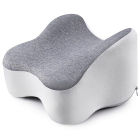 Anzhixiu knee pillow in side sleeping setup offers memory foam comfort and spine alignment.