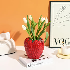 AOMOONOA strawberry vase on a bedside shelf provides a playful decor accent