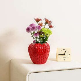 AOMOONOA strawberry vase on a dining table creates an eye catching spring centerpiece