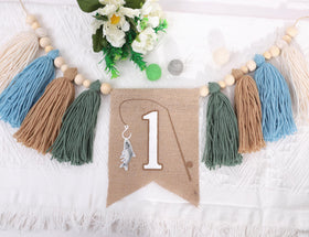 AOQURE Fishing One Birthday Banner near cake setup creates charming first birthday memories