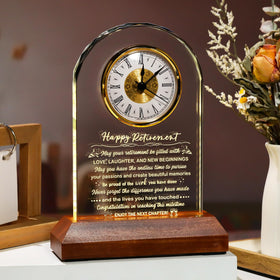 Close-up of Arikyrist glass clock engraving showing the message