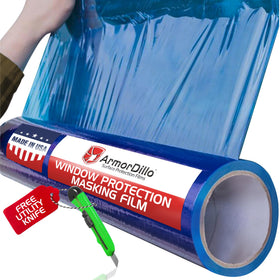 ArmorDillo blue window film protecting glass during painting tasks.