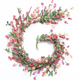 Artgar 6ft flower garland – full view showing vibrant year-round color on mantel and arch.
