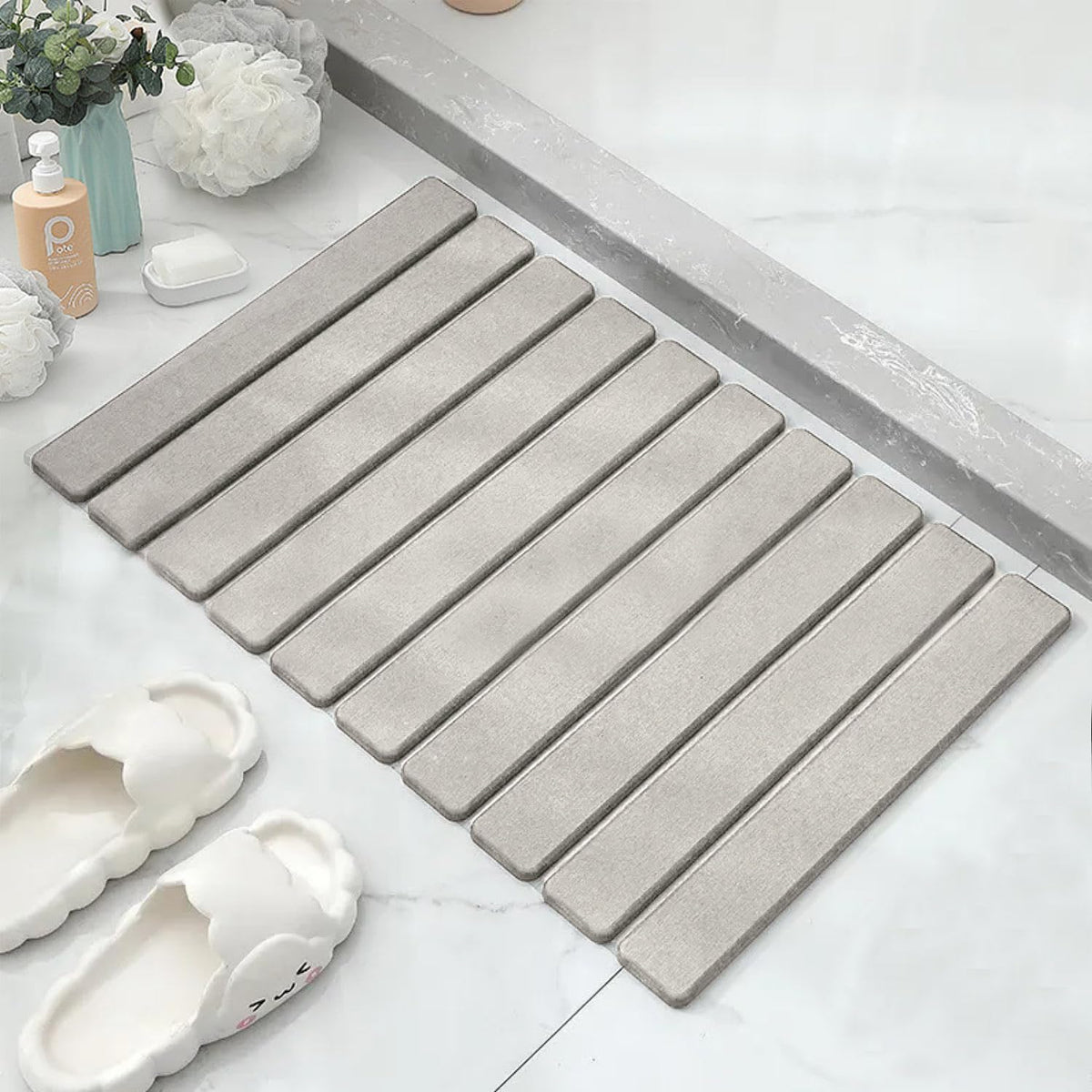 Asou Stone Bath Mat with diatomaceous-earth-absorbent surface dries floors.