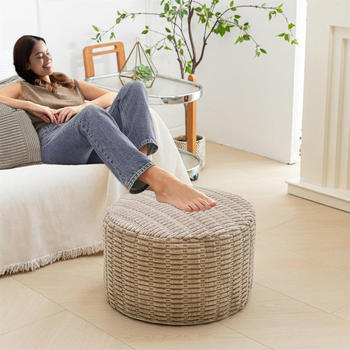 Asuprui pouf ottoman used with a coffee table offers extra seating and style.