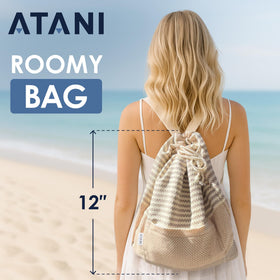 Folded ATANI Turkish Beach Towel fits compactly in a car or bag.