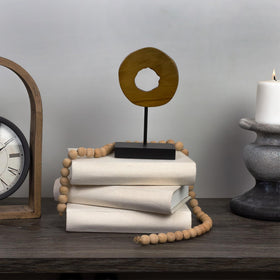 AuldHome Design faux book stack on mantel enhances cozy shelf decor