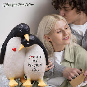 AUMELO anniversary gift penguin pair display on a shelf, celebrating lasting love.