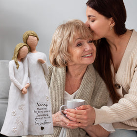 AUMELO nanny embrace with hand-painted details highlights delicate artistry for a cherished keepsake.