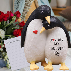 AUMELO penguin figurine on a desk, inspiring daily warmth and playful conversation.