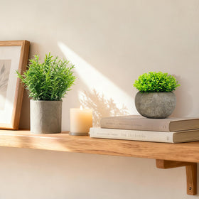 AUUGUU faux greenery in a minimalist cement pot boosts office desk ambiance.