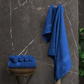 Avalon Towels royal blue bath towels drape neatly, signaling premium comfort.