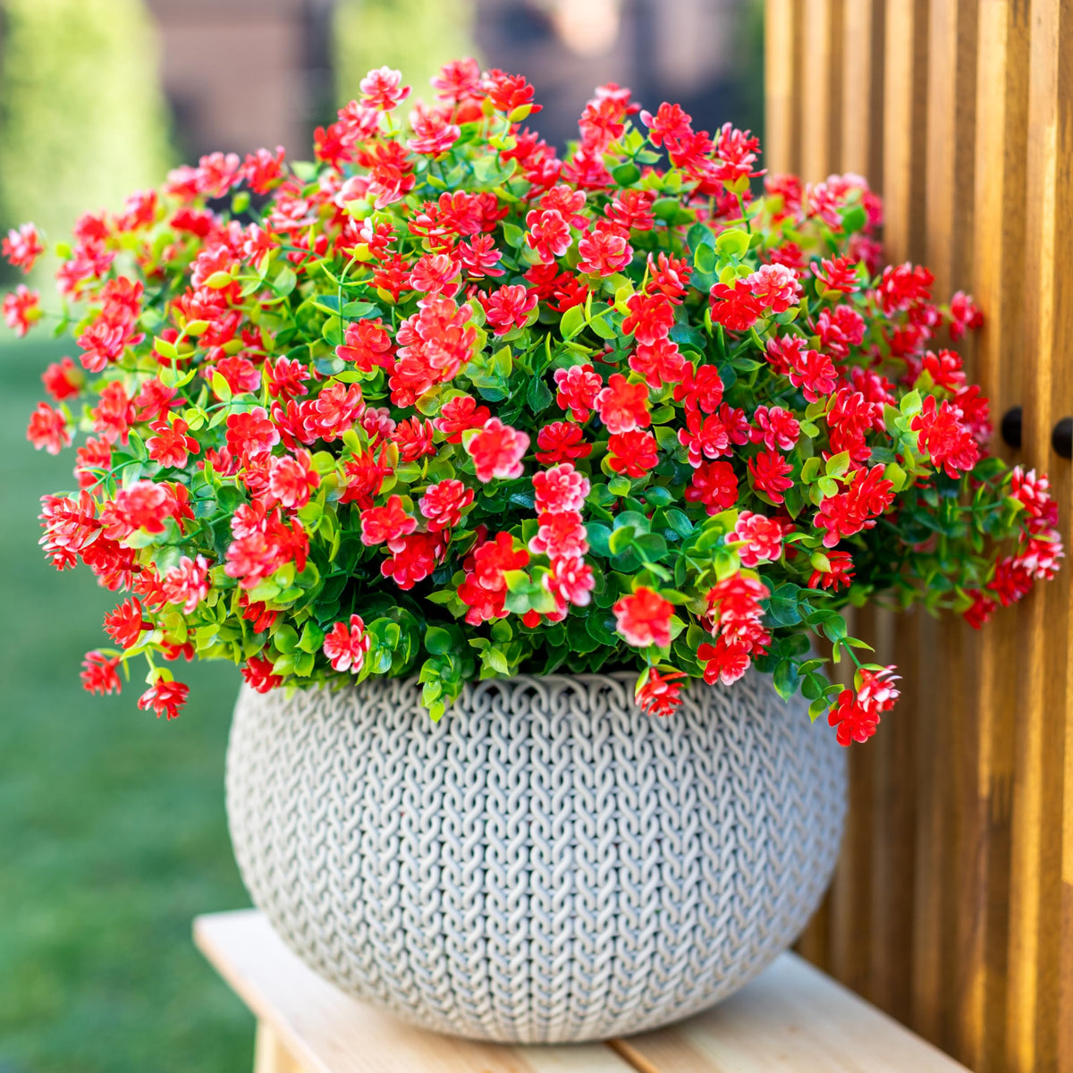 AXYLEX red outdoor faux flowers brighten front porch without maintenance.