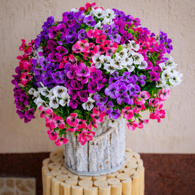 AXYLEX faux pansy plants decorate a garden corner with lush color.