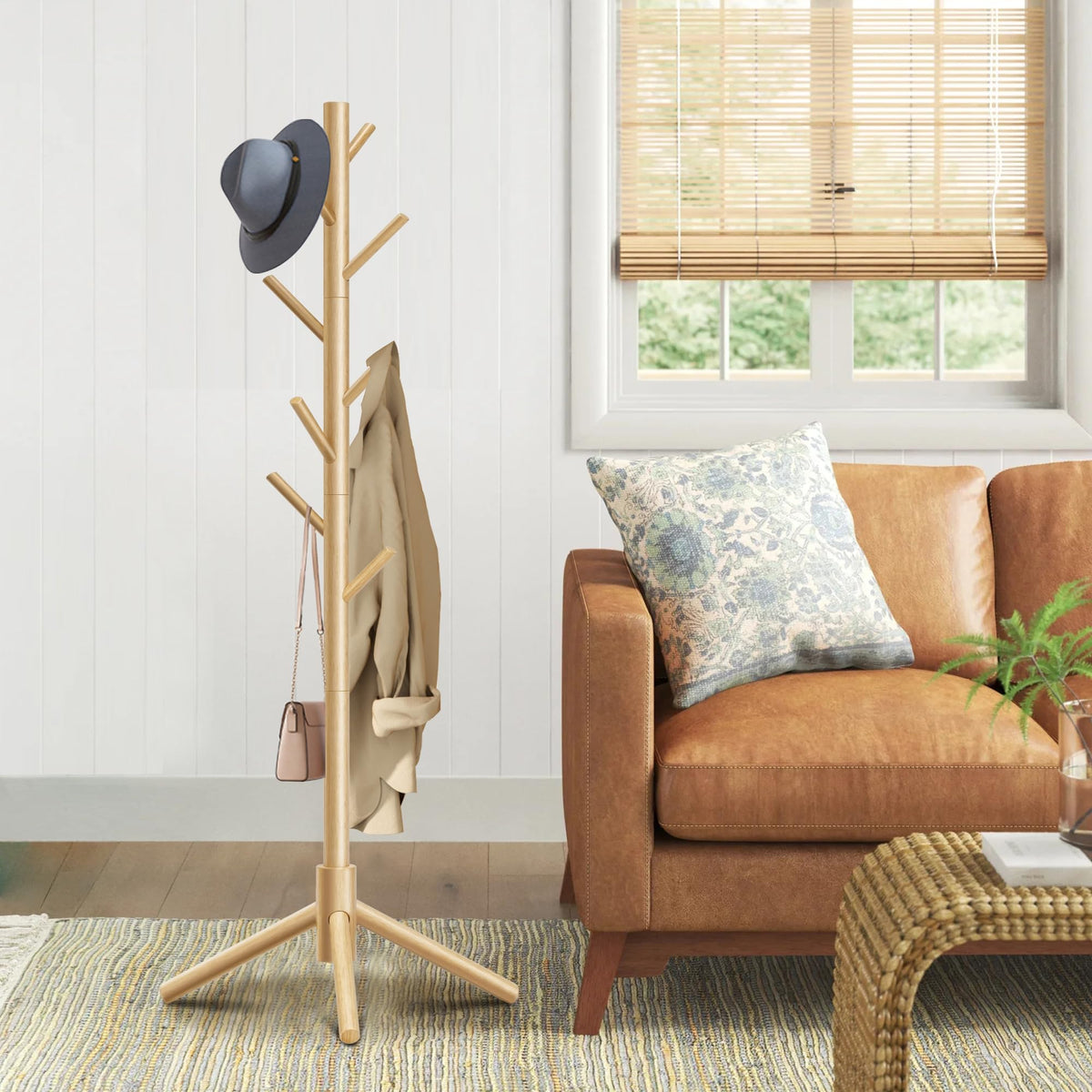 Azaeahom coat rack showing adjustable height feature for different users.
