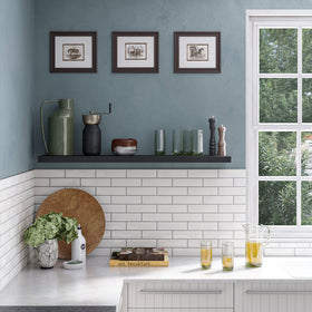 Ballucci kitchen decor display with frames and spices.