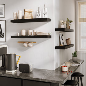 BAMEOS black shelf in living room with decor and books demonstrates display options.