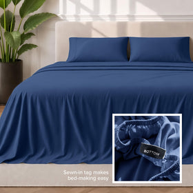 Bare Home dark blue queen sheets on bed display rich color.