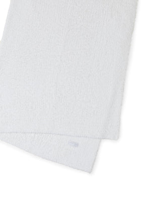 Barefoot Dreams CozyChic Throw drapes over bed for warm, inviting mornings.