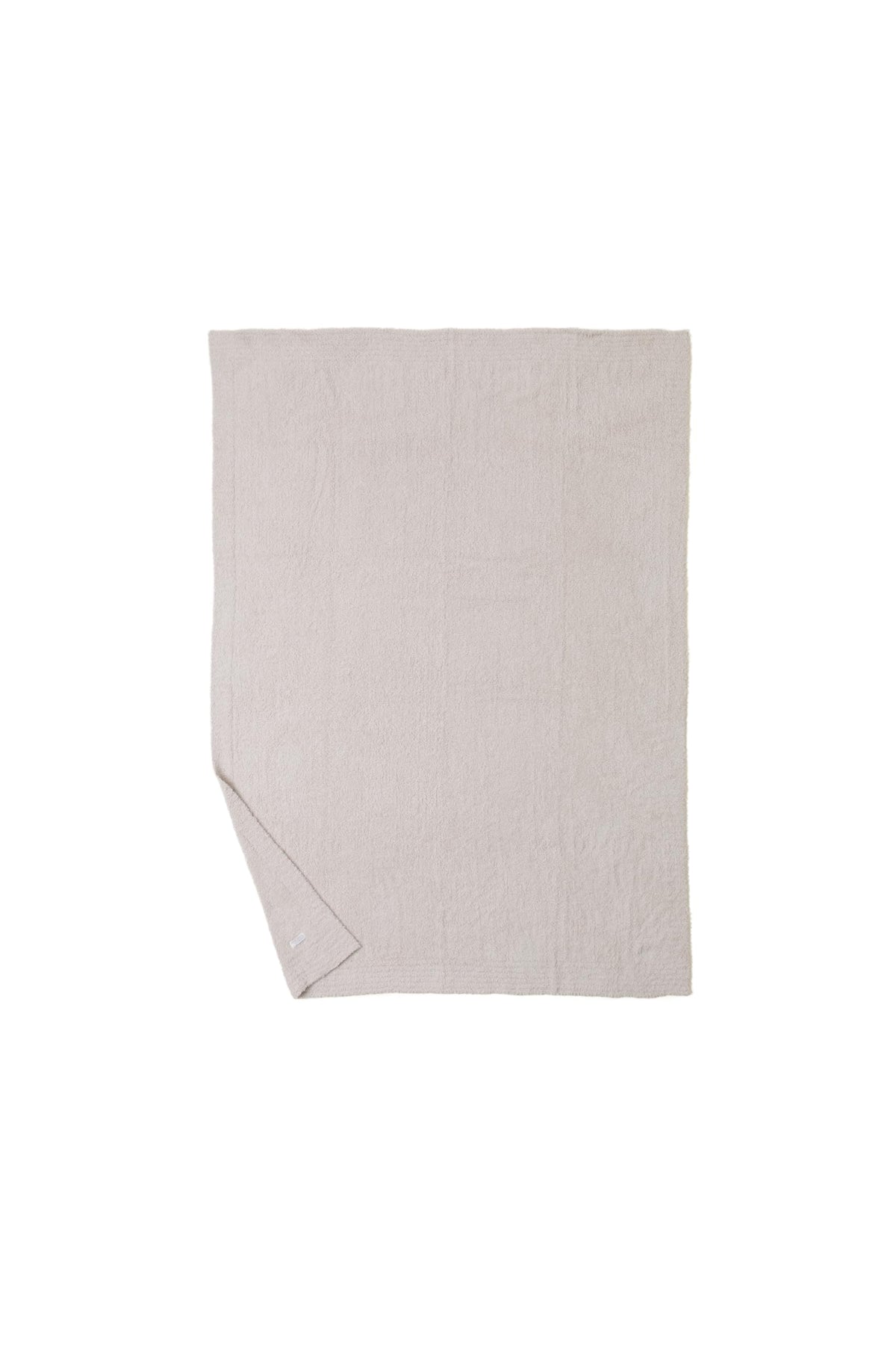Barefoot Dreams CozyChic Throw Stone beside the bed for easy snuggling