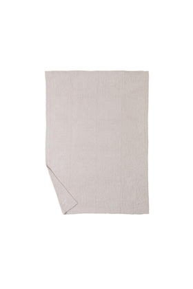 Barefoot Dreams CozyChic Throw Stone beside the bed for easy snuggling