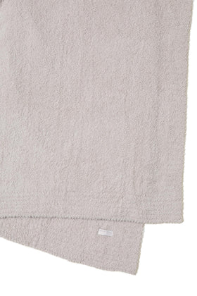 Barefoot Dreams CozyChic Throw Stone on sofa adding subtle luxury and texture