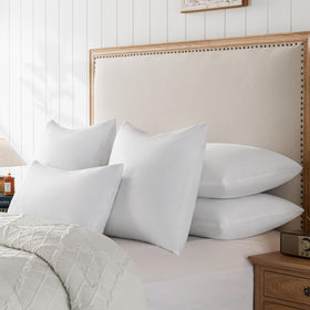 Basic Home 28x28 pillow insert placed beside a bed for cozy setup