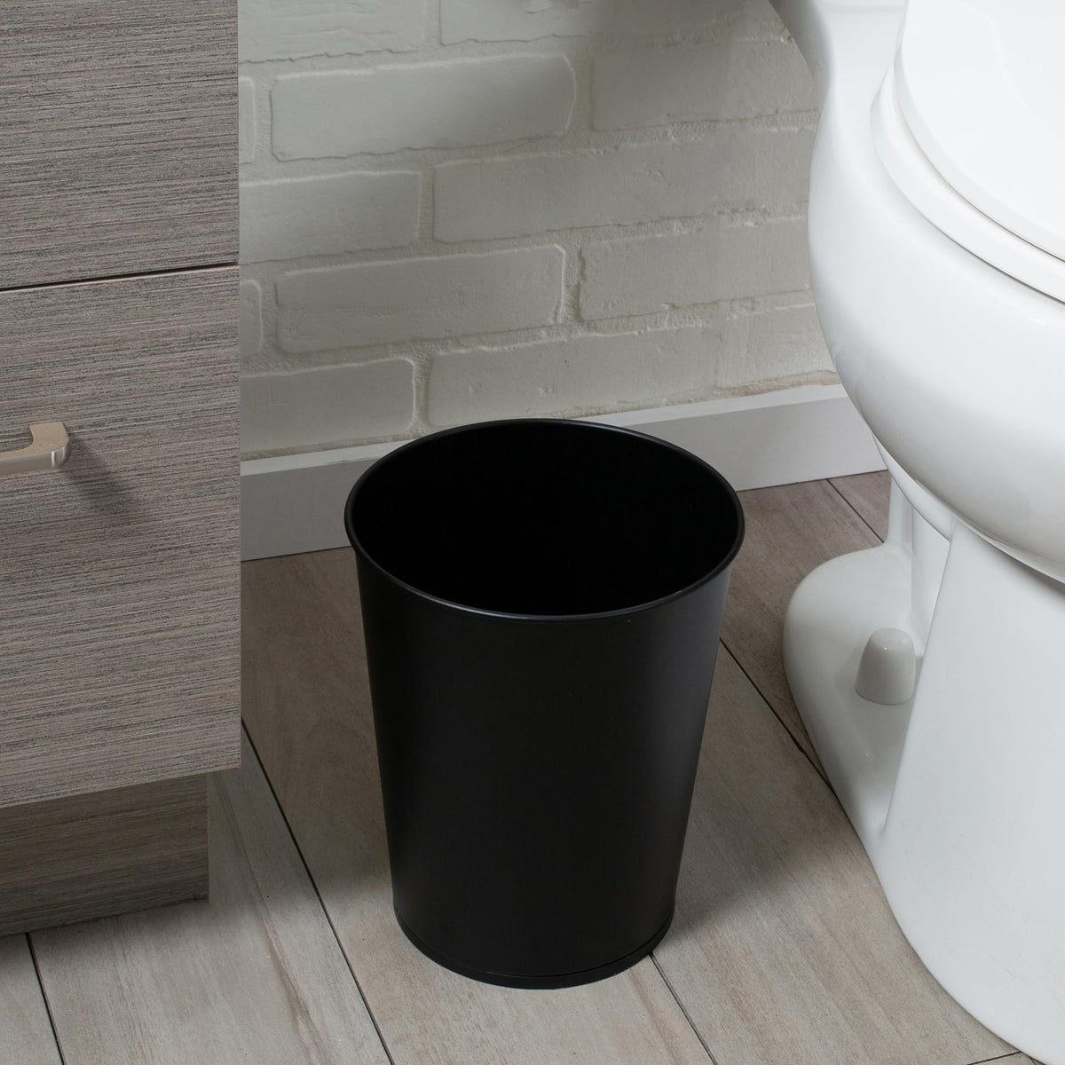 Hidden storage keeps plunger and brush concealed after use.