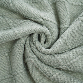 BATTILO HOME Sage Green Throw Blanket folded to showcase geometric pattern.
