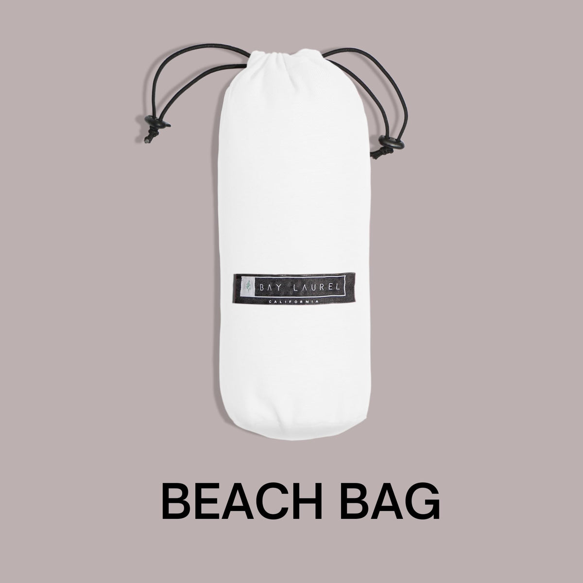 Bay Laurel Made in Türkiye towel with stylish design on sunlit sand.